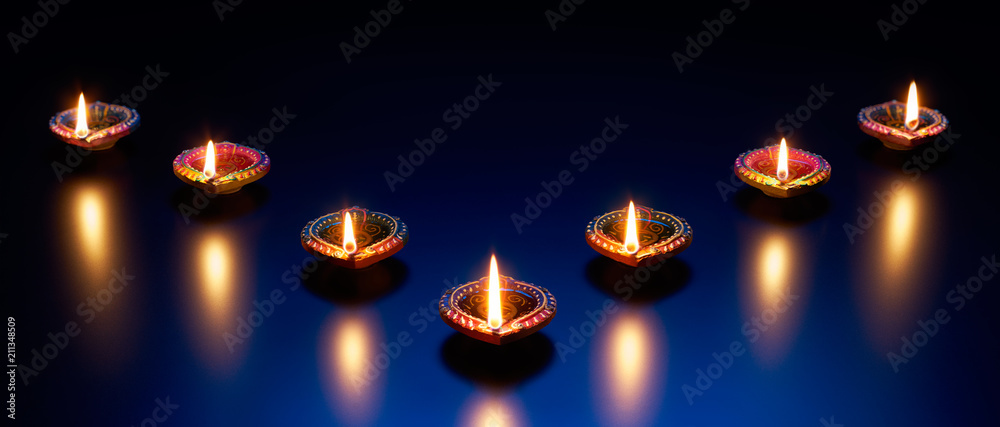 Diya lamps on a reflective base Diya lamps on a reflective base