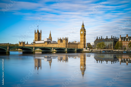Big Ben and Westminster with blue sky and water reflection