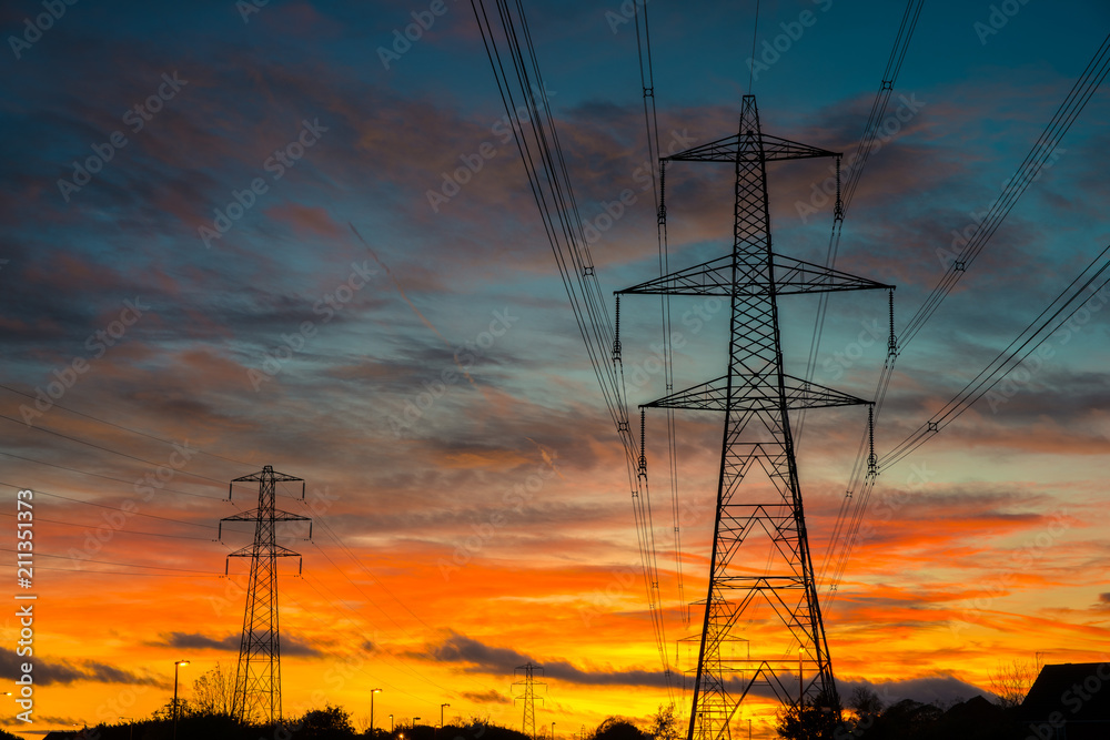 Hight voltage electric towers with sunset sky