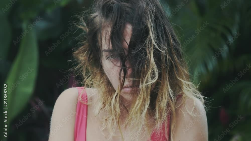 Close-up of the face of a young girl with short ombre hair, looks into the camera, looks away, hair falls on the face. The model came to the spa, skin care, natural oils, massage, beauty concept. Close-up of the face of a young girl with short ombre hair, looks into the camera, looks away, hair falls on the face. The model came to the spa, skin care, natural oils, massage, beauty concept.