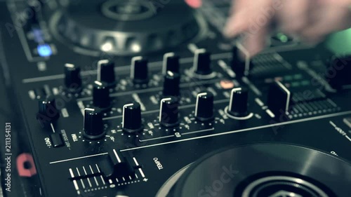 DJ tweak track controls on DJ control panel.