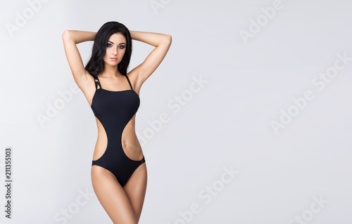 Slender and young girl with beautiful and fit body. Woman in swimsuit. Sport, diet, health and beauty concept.