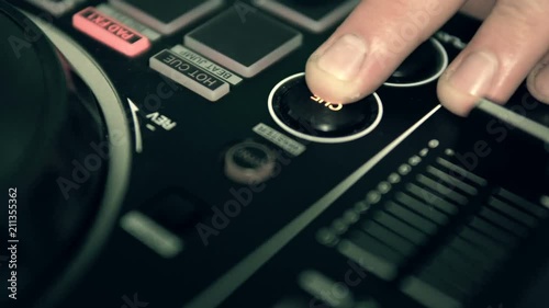 DJ tweak track controls on DJ control panel.
