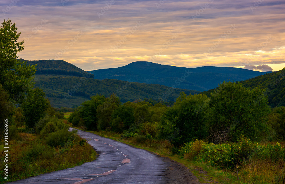 mountainous road on cloudy sunrise. lovely landscape in early autumn