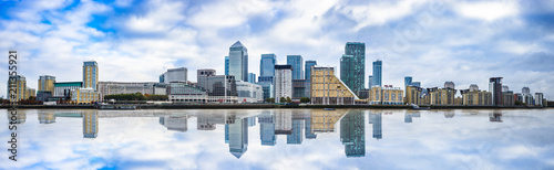 Panorama of Canary Wharf business district with water reflection
