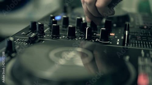 DJ tweak track controls on DJ control panel.