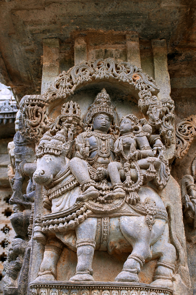 Ornate wall panel reliefs depicting Shiva-Parvati sitting on Nandi, North wall, Kedareshwara temple, Halebidu, Karnataka
