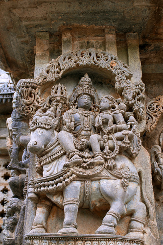 Ornate wall panel reliefs depicting Shiva-Parvati sitting on Nandi, North wall, Kedareshwara temple, Halebidu, Karnataka