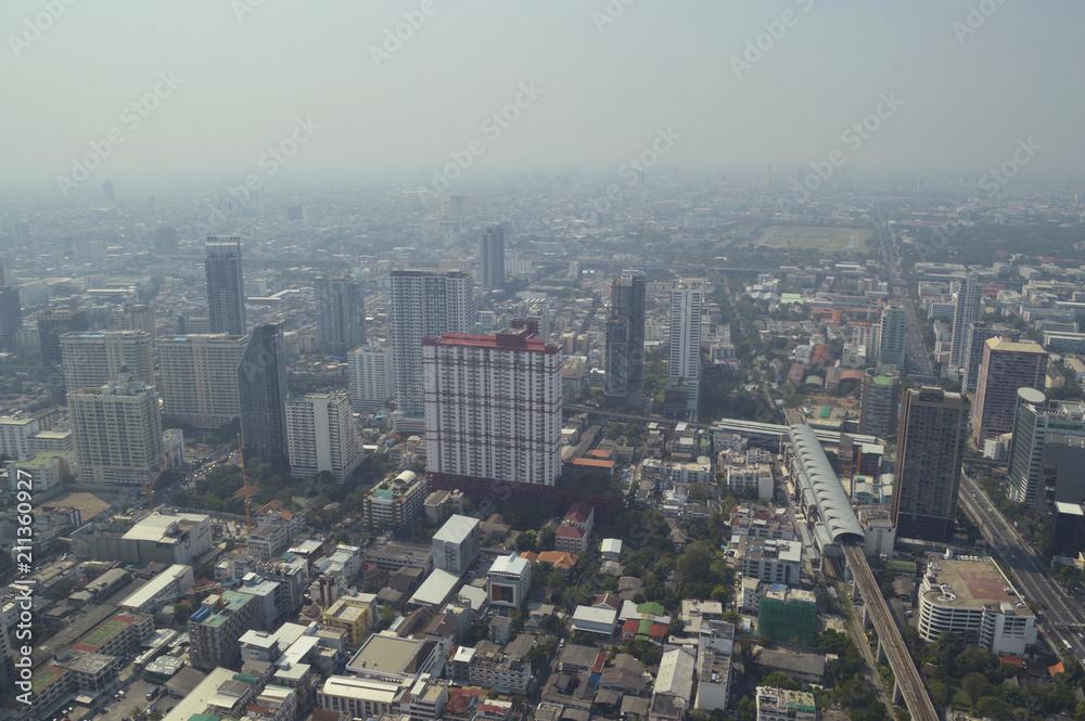Aerial view of modern office building tower, skytrain railway station and skyscraper in Bangkok Thailand
