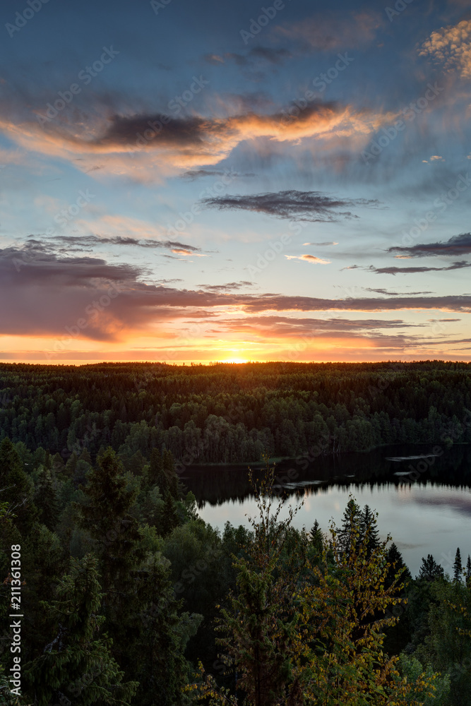 Scenic and beautiful view of a lake, forest and sky from the Aulanko lookout tower in Hämeenlinna, Finland, in the summer at sunrise. Copy space.