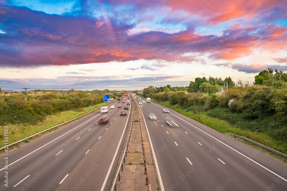 Colorful sunset at M1 with blurry cars in United Kingdom