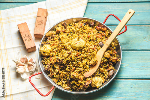 Pilaf with chicken.Chicken,rice,onion,carrots,vegetable oil.Ready pilaf mix,lay on the lagans,spread on top of rice chicken.Uzbek national dish. photo