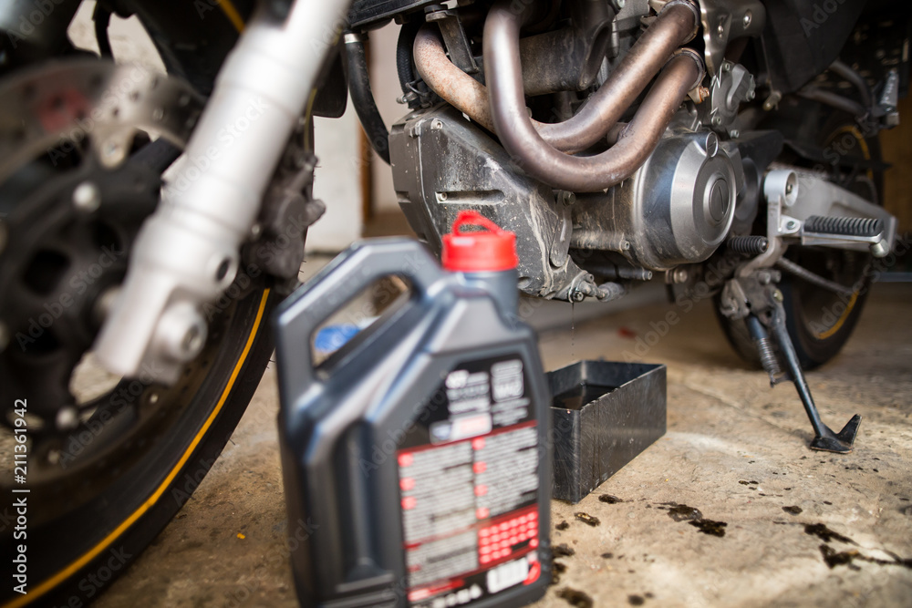 Motorbike and running oil from the engine, changing oil, regular maintenance Motorbike and running oil from the engine, changing oil, regular maintenance