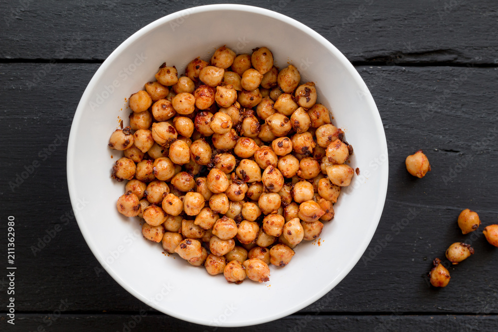 Chickpeas with spice in bowl on black background close up top view image Chickpeas with spice in bowl on black background close up top view image