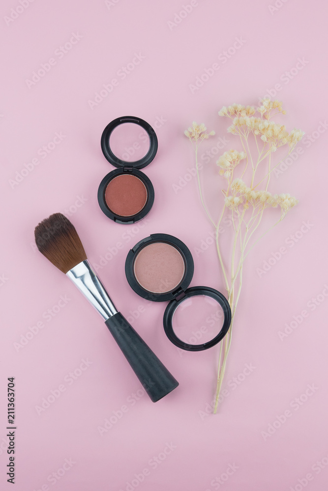 Pink blush and brush decorate with white dried flowers on pastel pink background Pink blush and brush decorate with white dried flowers on pastel pink background