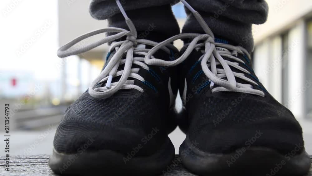 Freerunner jumping into focus revealing the tip of his shoes loww angle close up shot Freerunner jumping into focus revealing the tip of his shoes loww angle close up shot