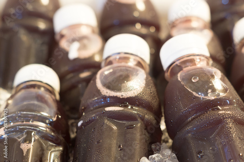 Black grape juice in bottles with white caps