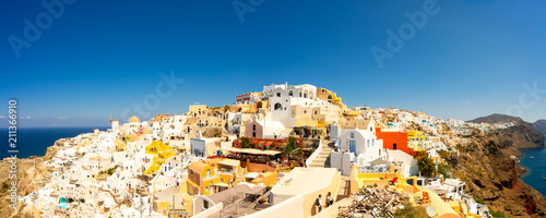 Panoramic view of Oia town, Santorini island, Greece Traditional and famous white houses and churches with blue domes over the Caldera, Aegean sea