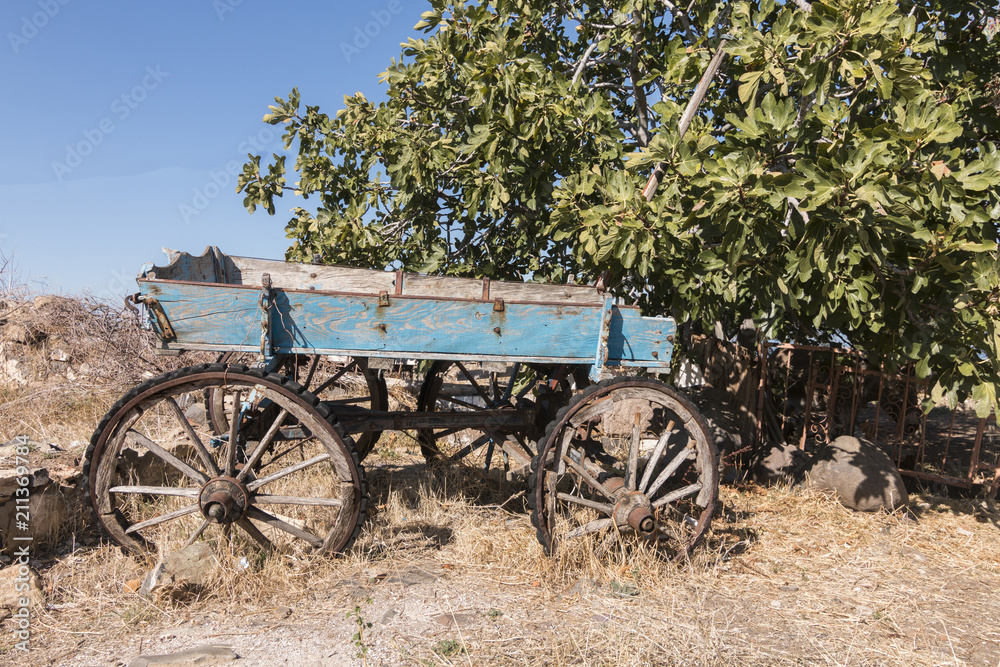 An old and disused blue carriage in a village in Cunda, Ayvalik, Turkey