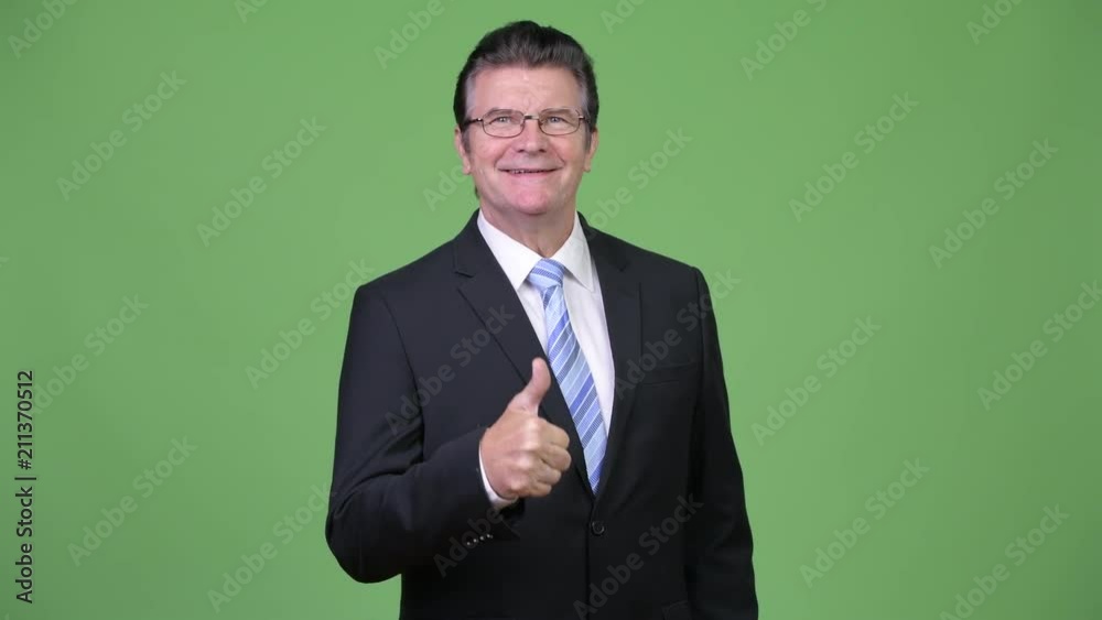 Senior handsome businessman giving thumbs up Senior handsome businessman giving thumbs up