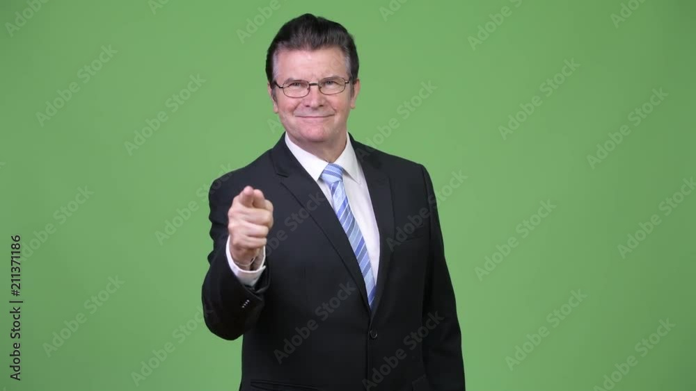 Senior handsome businessman pointing to camera Senior handsome businessman pointing to camera