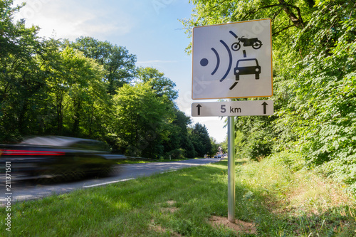 Speed limit speed camera sign close to the road photo