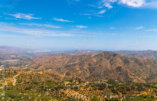 beautiful view of the mountains in the region of Andalusia, houses and farmland on the slopes of mountains