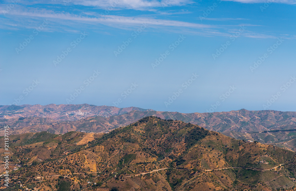 beautiful view of the mountains in the region of Andalusia, houses and farmland on the slopes of mountains