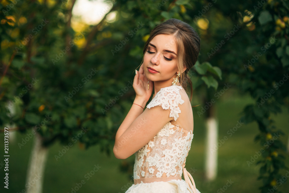 Girl in wedding dress. Beautiful girl in garden Girl in wedding dress. Beautiful girl in garden