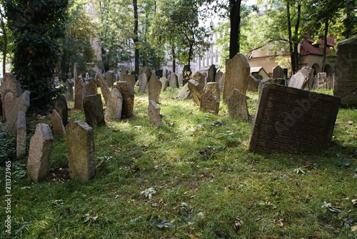 Historic old Jewish cemetery with rock tombs in Prague and broken monuments by the passage of time photo