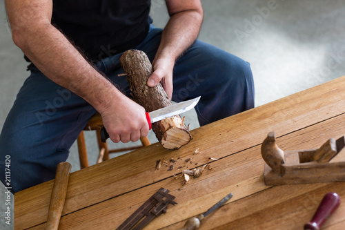 man making three tealight candle holders from rustic wood