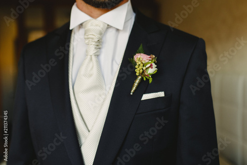Groom dressing to go to his wedding