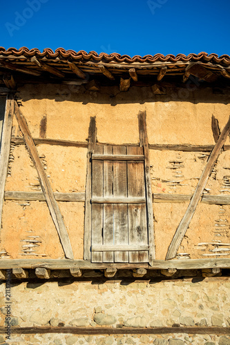 Medieval wooden door of old vintage abandoned earthen barn in the Bulgarian village of Chavdar in Stara Planina mountain photo