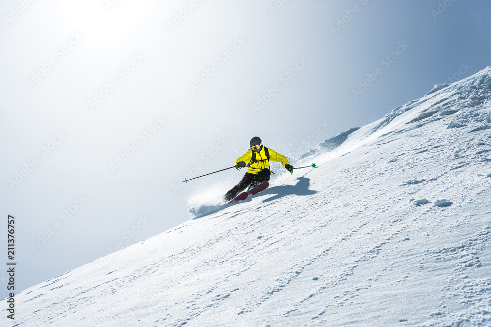 The total length of skiing on fresh snow powder. Professional skier outside the track on a sunny day