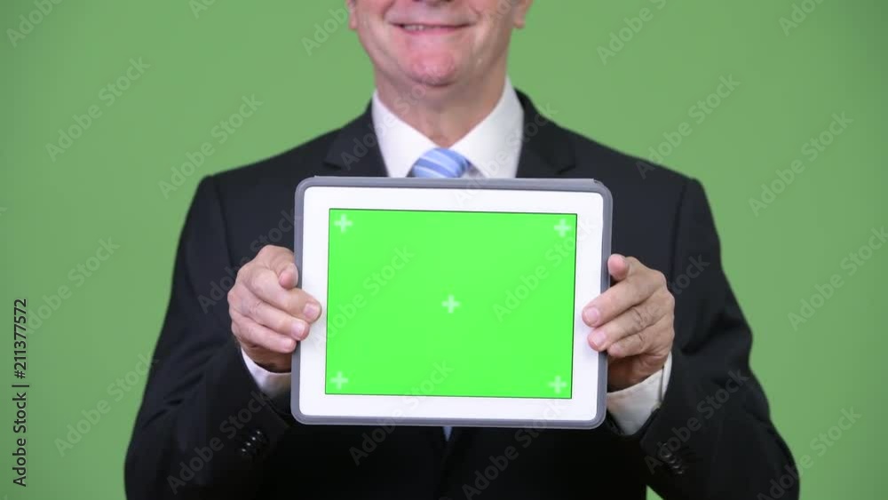 Senior handsome businessman showing digital tablet Senior handsome businessman showing digital tablet