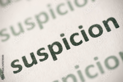 word suspicion printed on paper macro