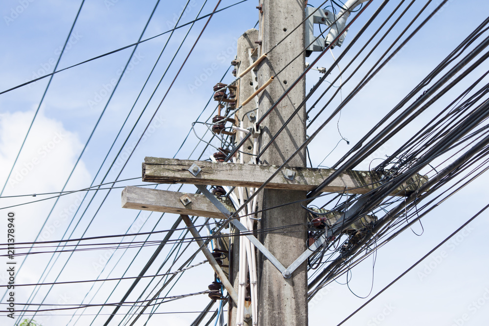 The electrical wires on the power poles are made of cement under blue sky. The electrical wires on the power poles are made of cement under blue sky.