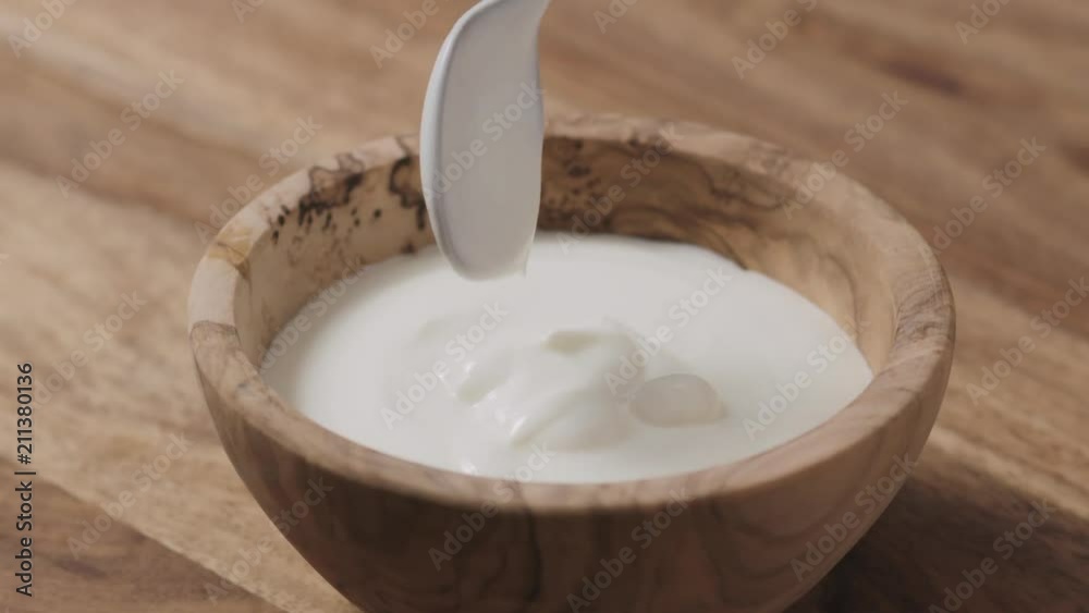 Slow motion of mixing sour cream with spoon Slow motion of mixing sour cream with spoon