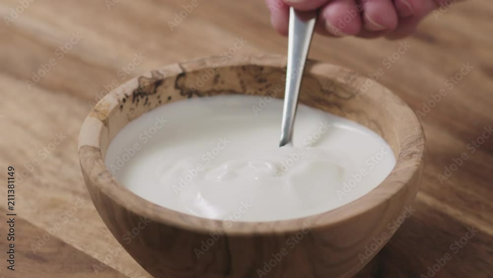 Slow motion of taking sour cream with spoon Slow motion of taking sour cream with spoon
