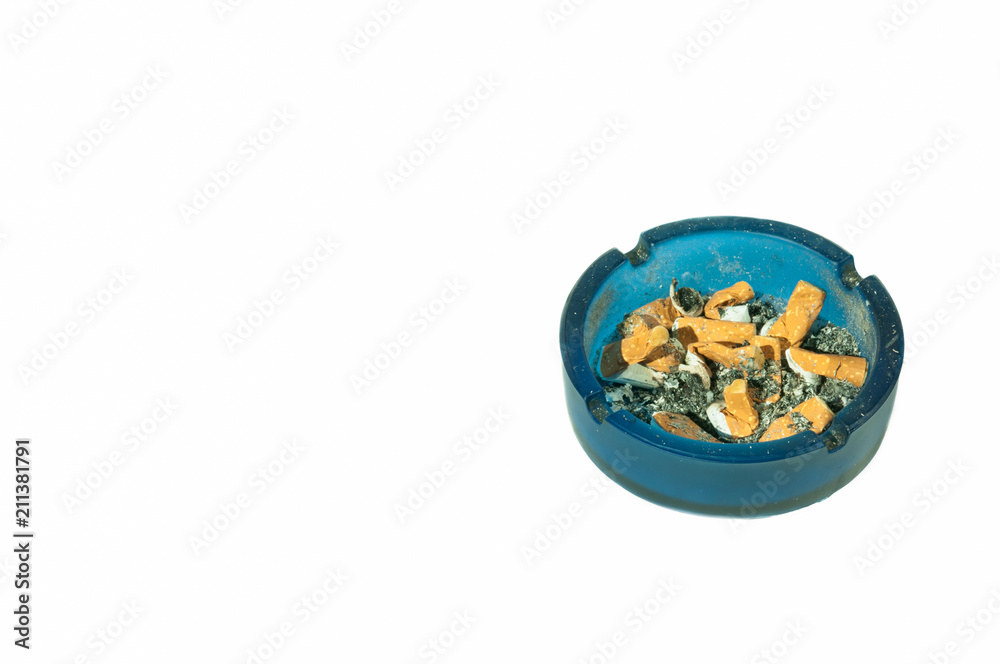 Dirty blue glass ashtray full of cigarette buts and ash after smoke, partially isolated on white background view from above Dirty blue glass ashtray full of cigarette buts and ash after smoke, partially isolated on white background view from above