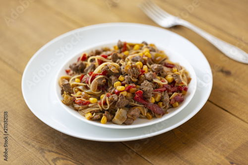 Noodles with meat and vegetables in sweet and sour sauce.