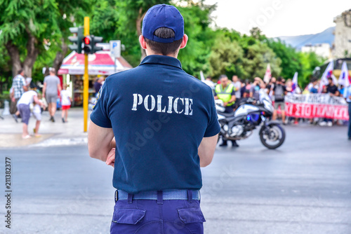 Fototapeta Naklejka Na Ścianę i Meble -  Chania , Greece - June 14, 2018 : Greece policeman working for street safety during local picket, editorial photo.