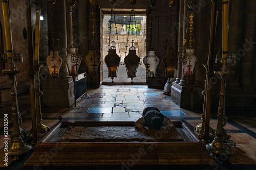 Worship at the Stone of Anointing in Church of the Holy Sepulchre in Jerusalem photo