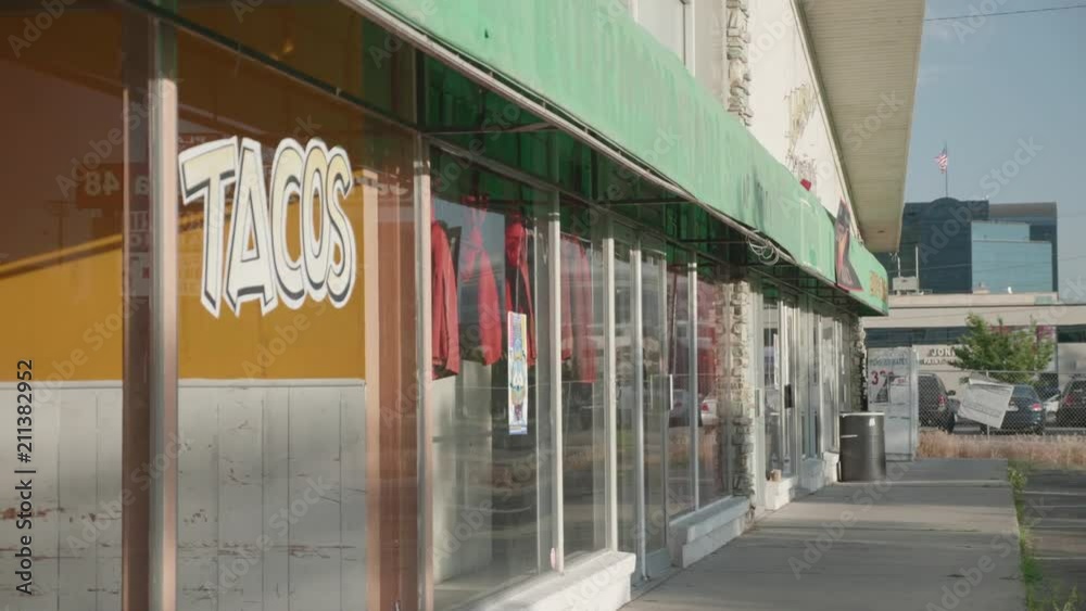 A close up shot of a rundown and deserted storefront with old window paint.