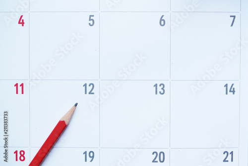 close up of organizer or calendar and red pencil, planning for business meeting or travel planning concept