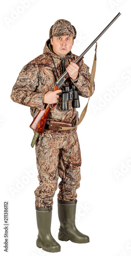 Full length portrait of a male hunter with double barreled shotgun Isolated on white background. hunting and people concept.