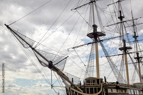 An old sailing ship without sails at the pier.