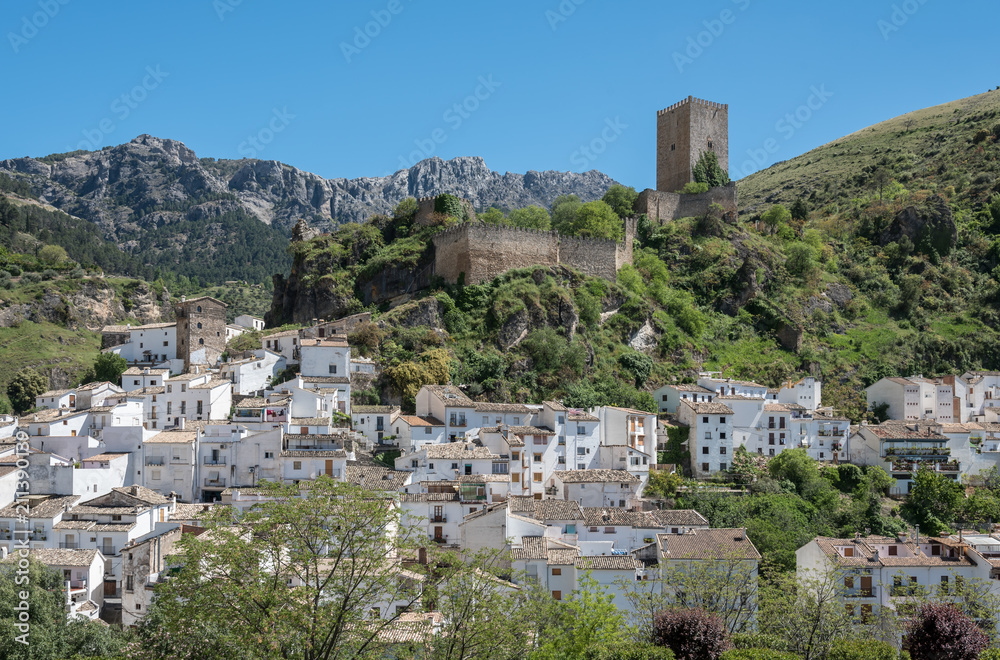 Picturesque town Cazorla with moorish fortress tower La Yerda and typical white houses surrounded by mountain range Sierra de Cazorla. Andalusia, Spain