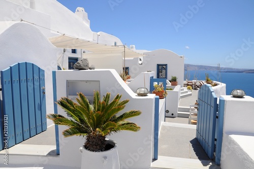 Famous stunning view of white architectures and colors above the volcanic caldera in the village of Oia in Santorini island, Greece