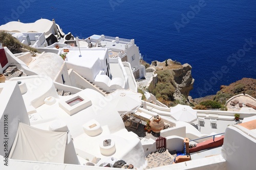 Famous stunning view of white architectures and colors above the volcanic caldera in the village of Oia in Santorini island, Greece